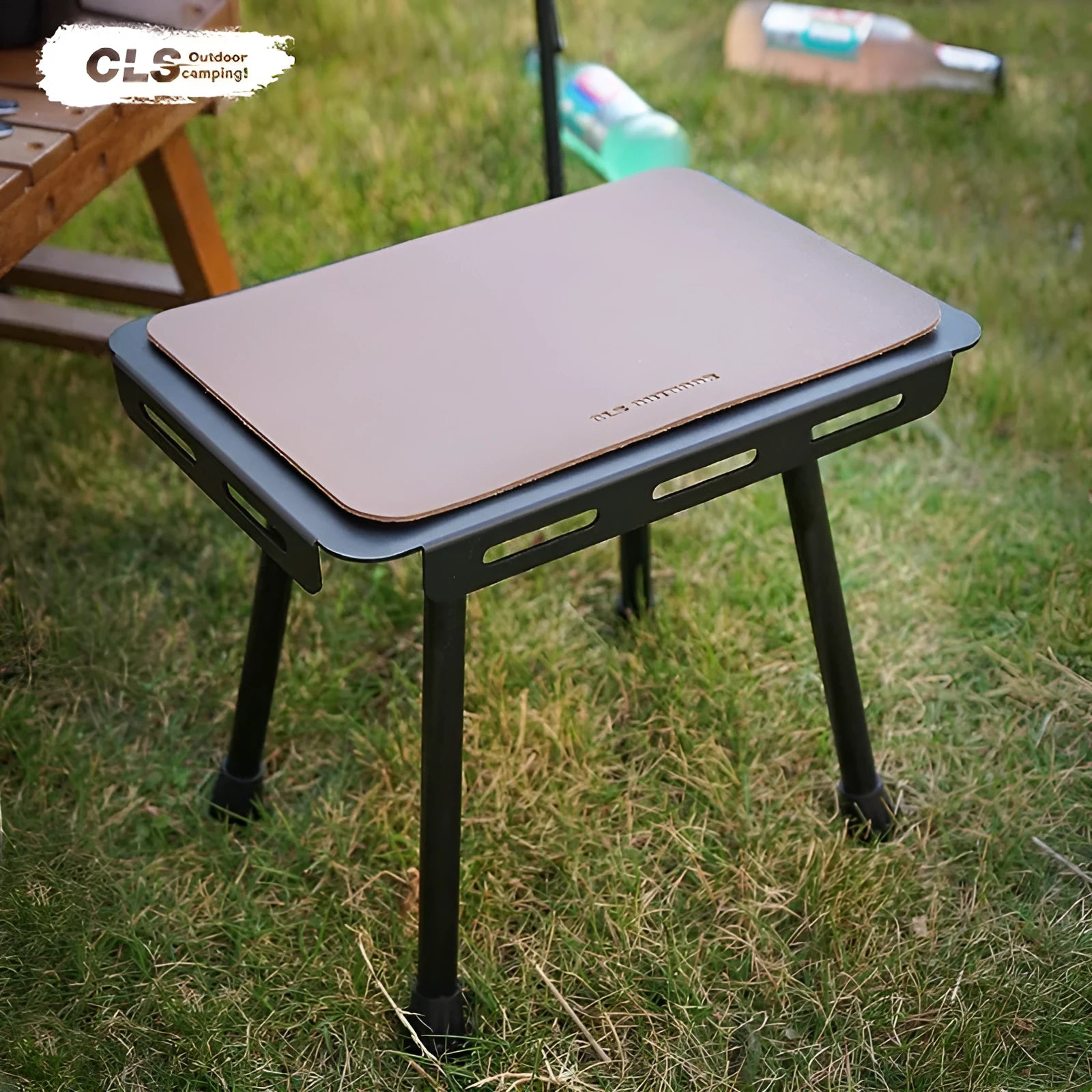 Aluminium folding stool set up as a small table with a beige PU mat cushion, next to its storage bag.