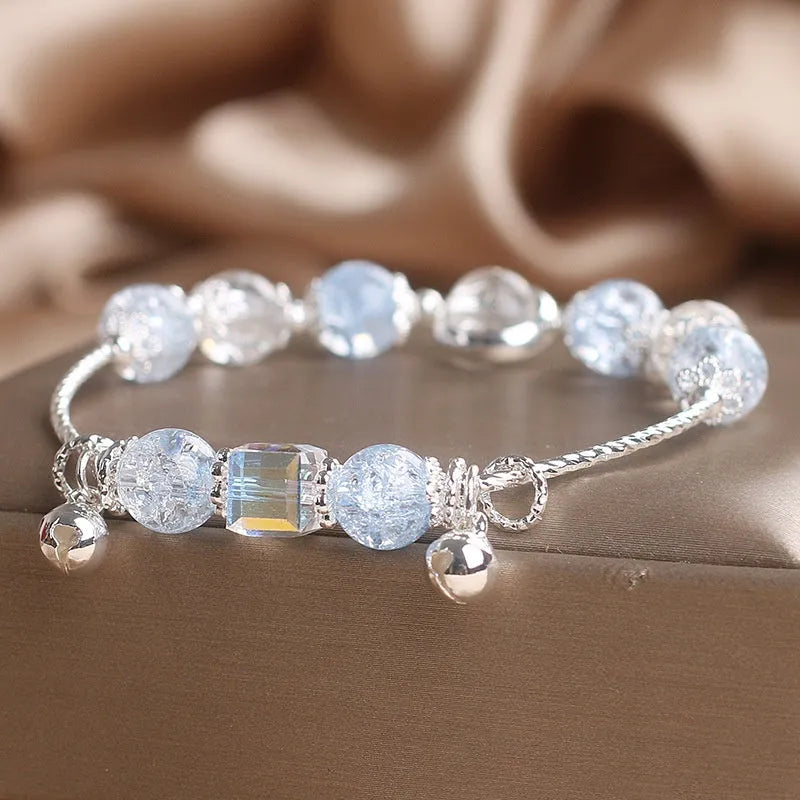 Light blue artificial crystal bell bracelet on woman's wrist