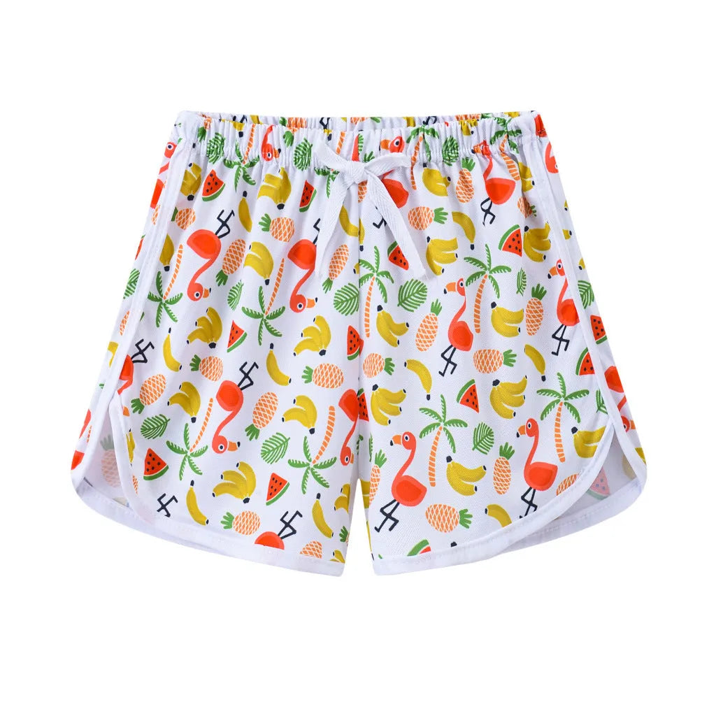 Children's polyester holiday shorts in multiple colours and patterns including stripes, leopard print, and pineapple design.