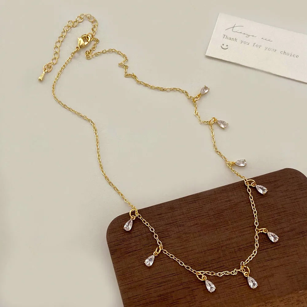 Three-piece zircon jewellery set for women showing necklace, earrings, and anklet with geometric meteor shower design.