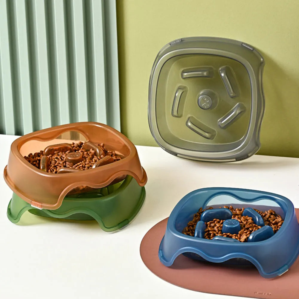 Blue plastic dog slow feeder bowl on a floor, designed to prevent choking by slowing eating pace.