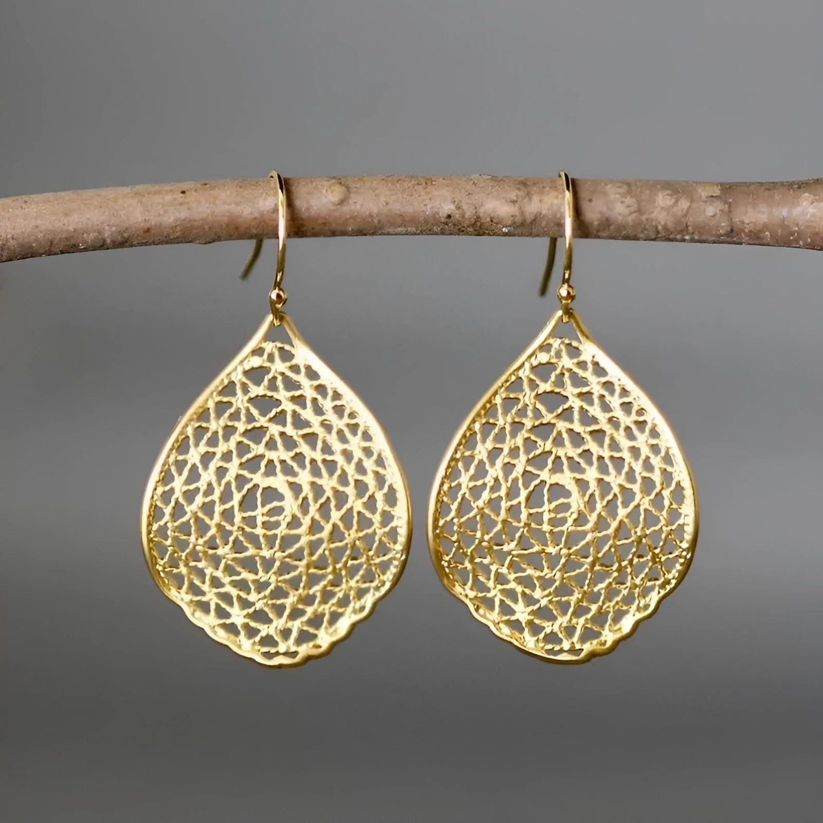 Gold retro leaf hollow drop earrings with pendant design