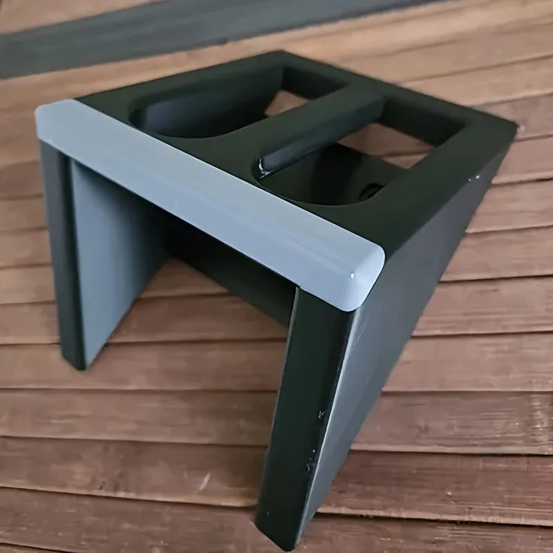 Black punk-style plastic pistol display stand on a flat surface.