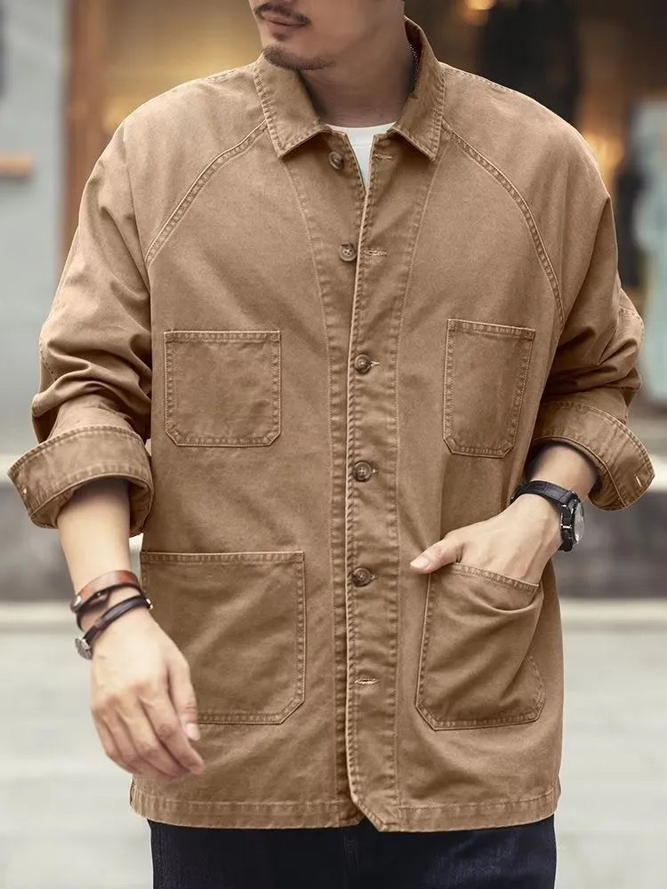 Men's khaki cotton blend denim jacket with loose fit and multiple pockets on a plain background