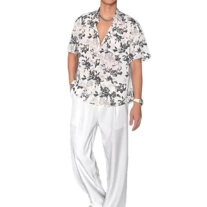 Loose fitting floral printed short sleeve shirt in black on a hanger