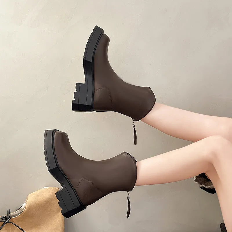 Black women's platform ankle boots with a square toe, chunky sole, and a back zip fastener.