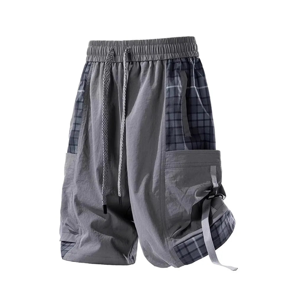 Man's loose-fit cargo shorts in grey with plaid stitching detail on the legs.