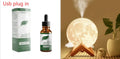Wood finish spherical lunar humidifier and night light on a bedside table.