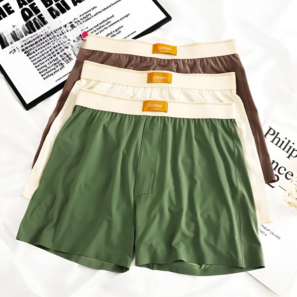 Men's solid colour loose fit ice silk boxer shorts on a mid waist, shown in dark grey.