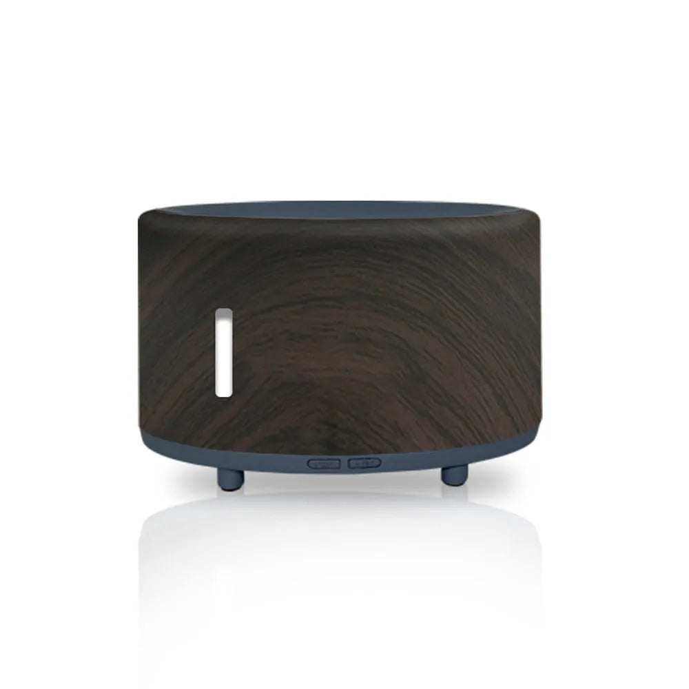 Flame effect humidifier and essential oil diffuser with Bluetooth remote on a table.