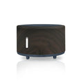 Flame effect humidifier and essential oil diffuser with Bluetooth remote on a table.