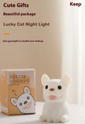Soft silicone USB night light with dimmer in a cartoon animal design on a bedside table.
