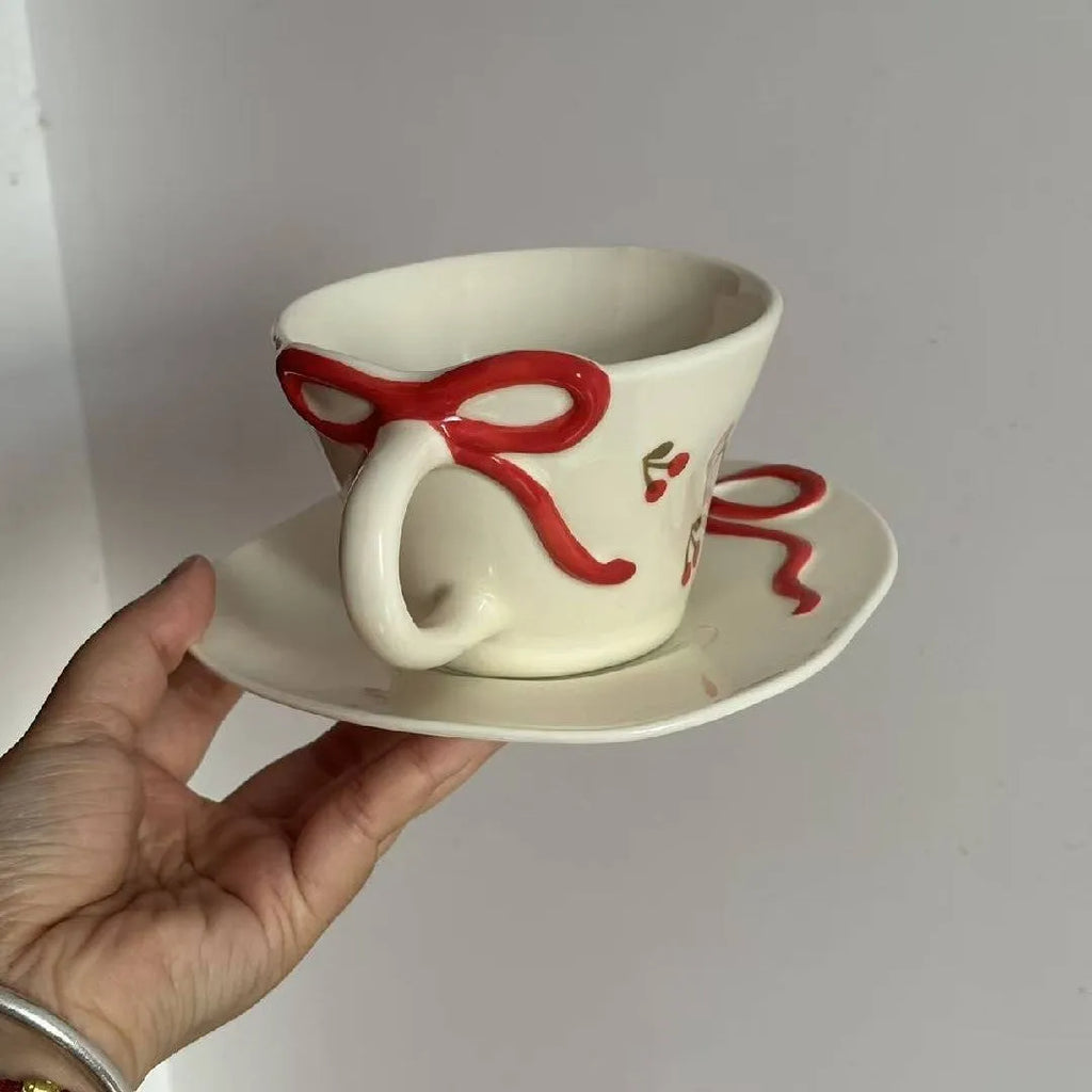 Hand painted white porcelain coffee cup with cherry design and matching coaster
