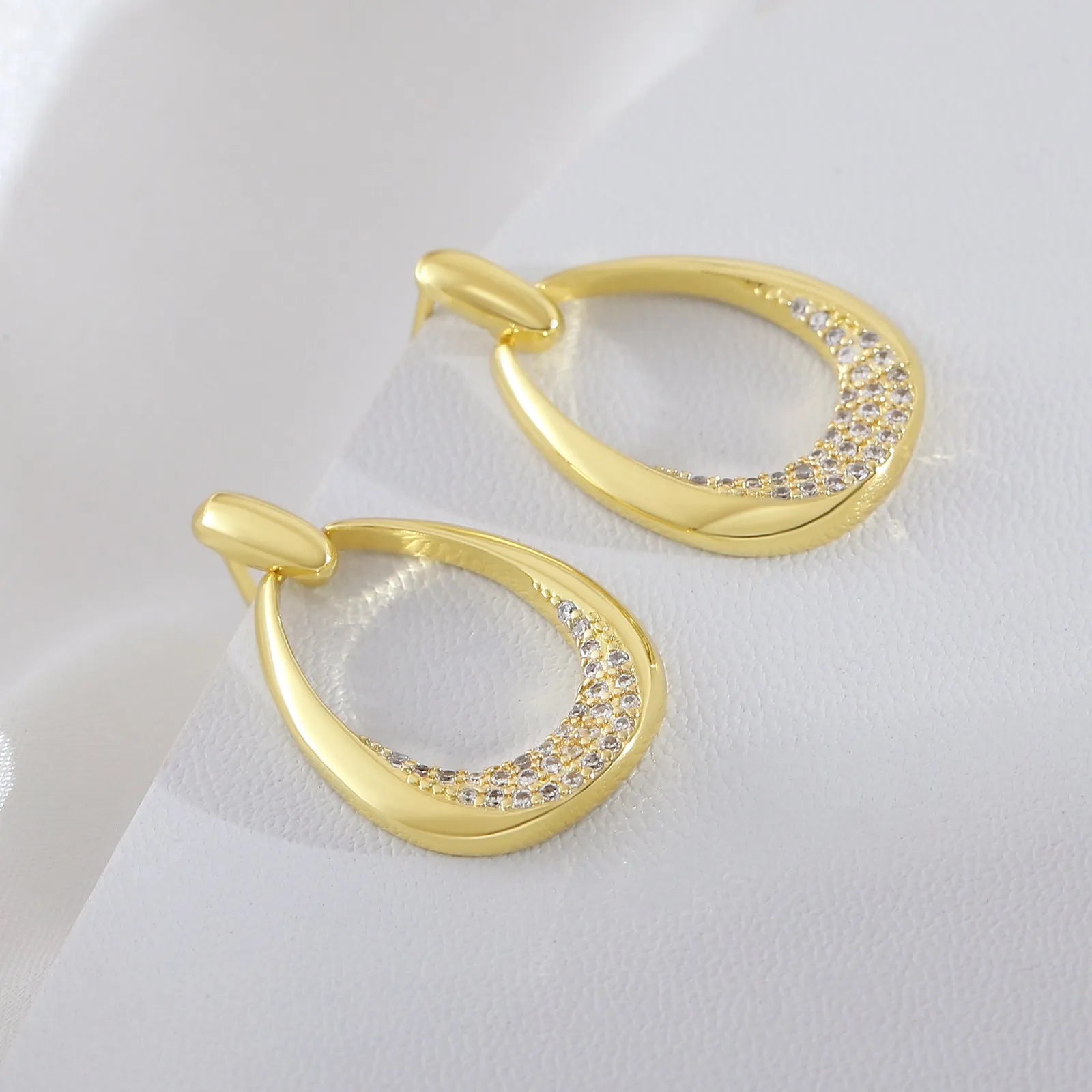 Women's yellow gold geometric drop earrings with ring and oval elements measuring 2.6 by 1.7 cm