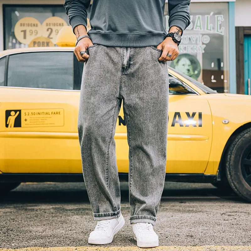 Men's loose fit straight leg casual jeans in dark blue, shown on a hanger.