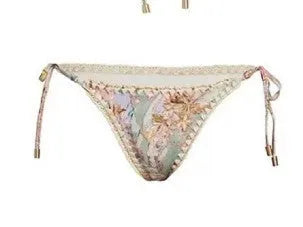 Women's creamy white floral bikini set with top, briefs, and matching skirt on a mannequin.