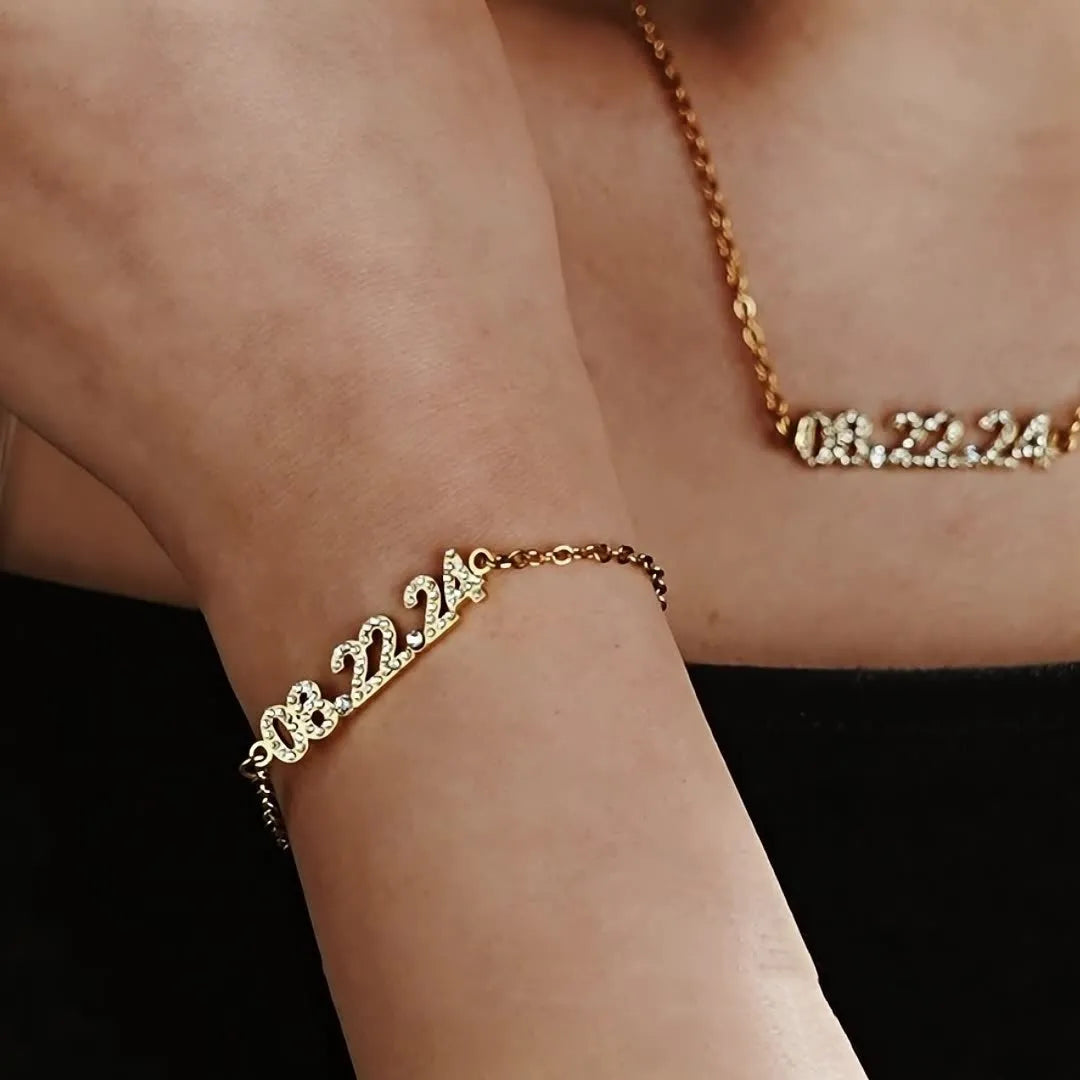Stainless steel digital bracelet and necklace with diamond-set numbers in gold, rose gold, or steel colour.