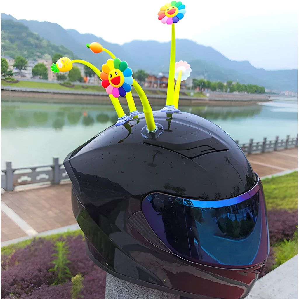 Yellow silicone sunflower decoration with a suction cup base for attaching to a helmet.