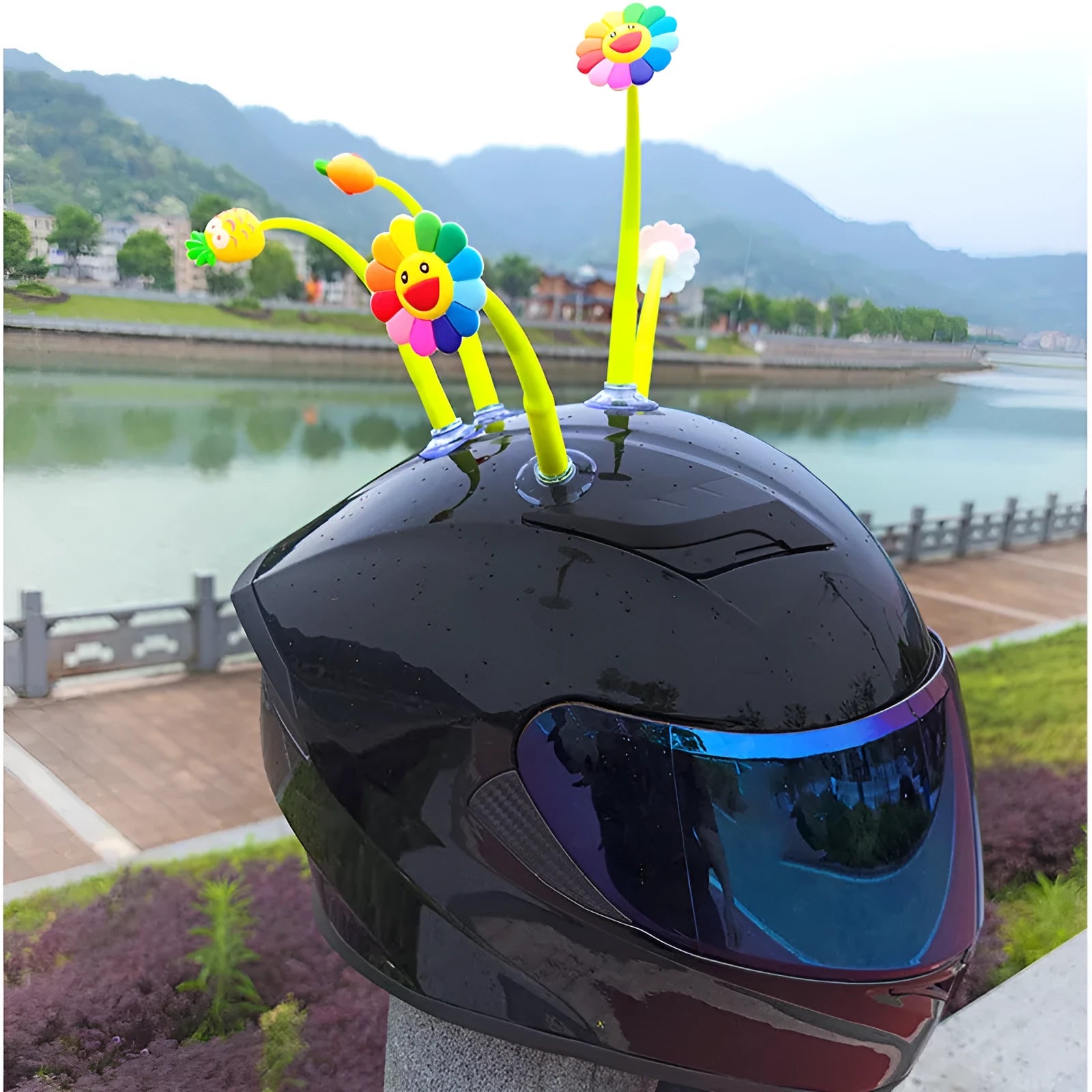 Yellow silicone sunflower decoration with a suction cup base for attaching to a helmet.