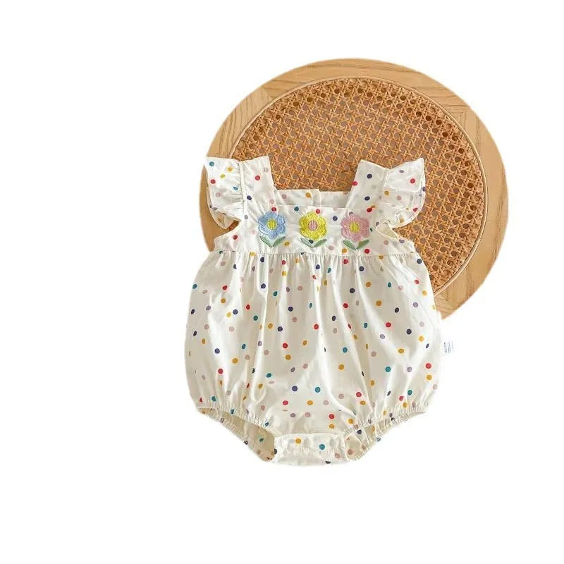 Beige cotton newborn summer jumpsuit with polka dots and flounced sleeves on white background