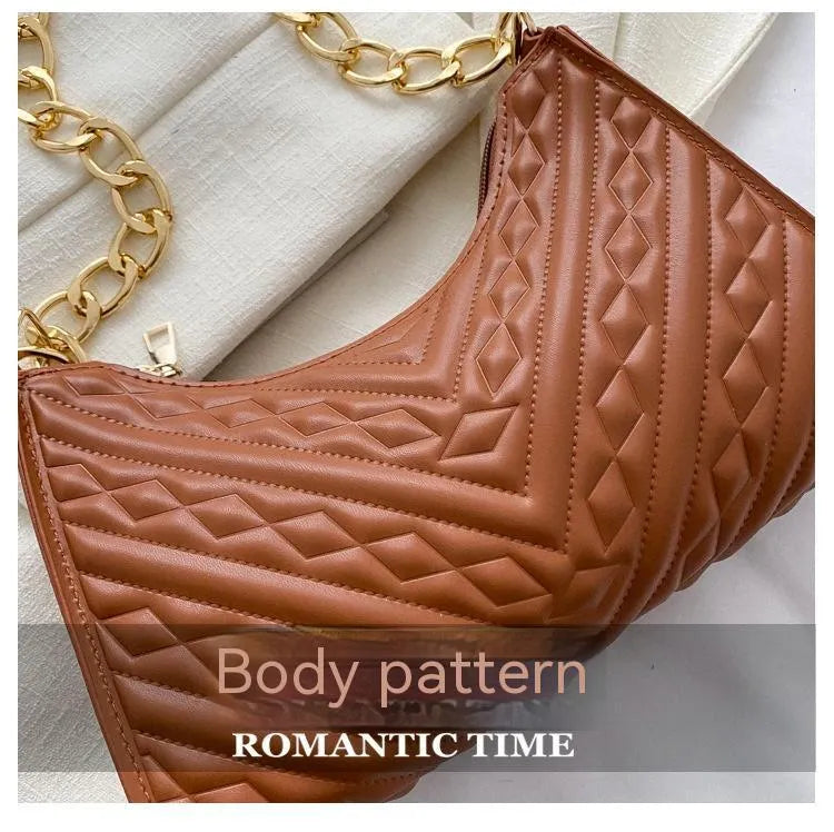 Brown pleated chain shoulder bag with soft handle and adjustable strap showing sewing line detailing