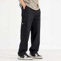 Women's loose wide-leg polyester blend trousers in black, mid-waist drawstring elastic waist, flat lay