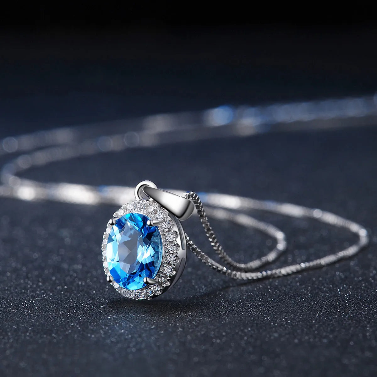 925 sterling silver jewellery set with blue topaz stones showing earrings, ring, pendant and necklace in geometric design