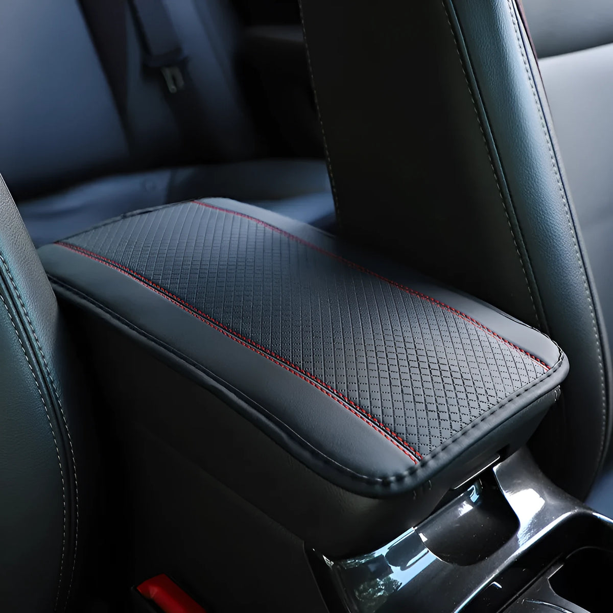 Automotive fibre leather embossed armrest box mat measuring 32x19cm in black with red cord detailing