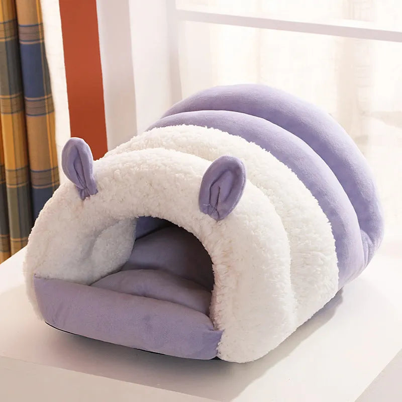 Blue closed hooded cat nest bed showing padded interior and washable cover.