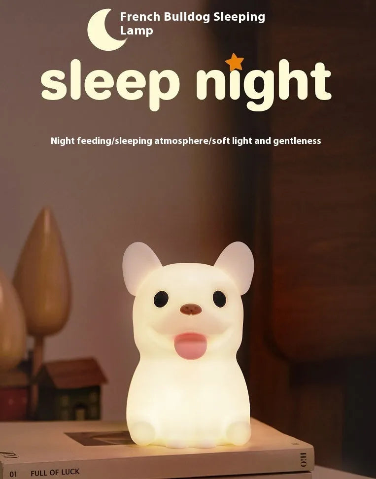 Soft silicone USB night light with dimmer in a cartoon animal design on a bedside table.