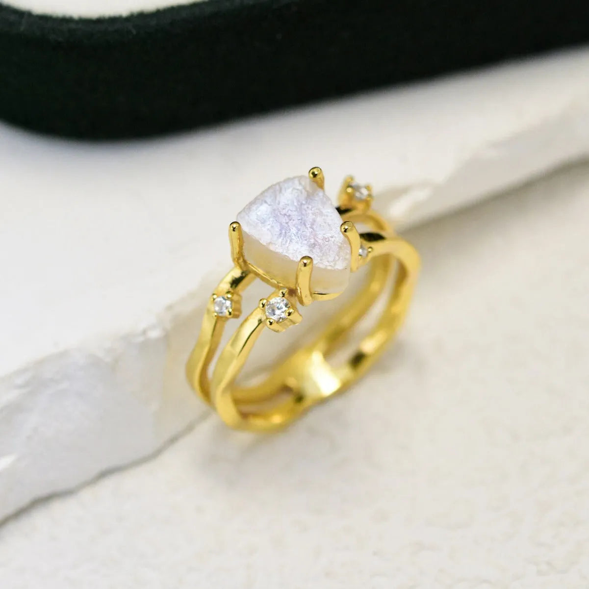 S925 silver geometric ring with triangular moonstone in rose, white, or yellow gold plating on a size guide.
