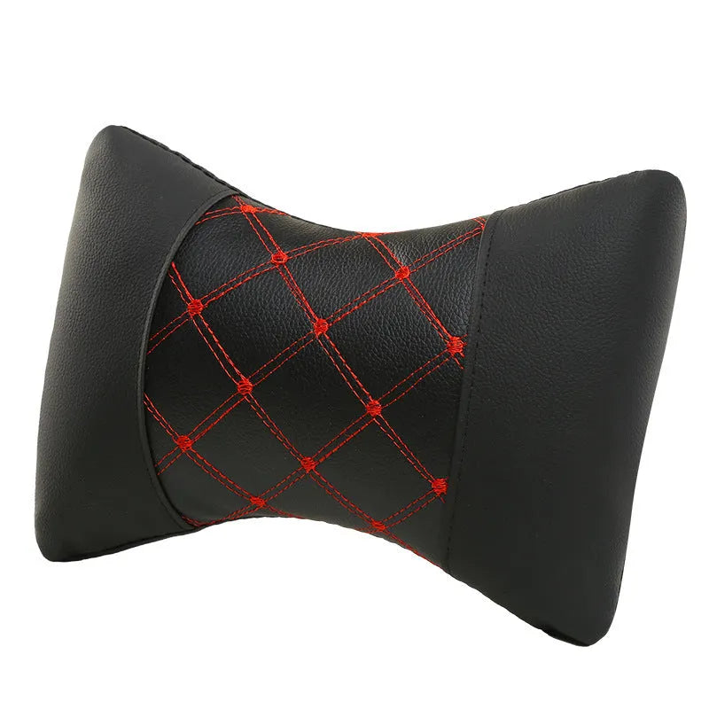 Black quilted diamond pattern car headrest cover with blue stitching, shown on a car seat.