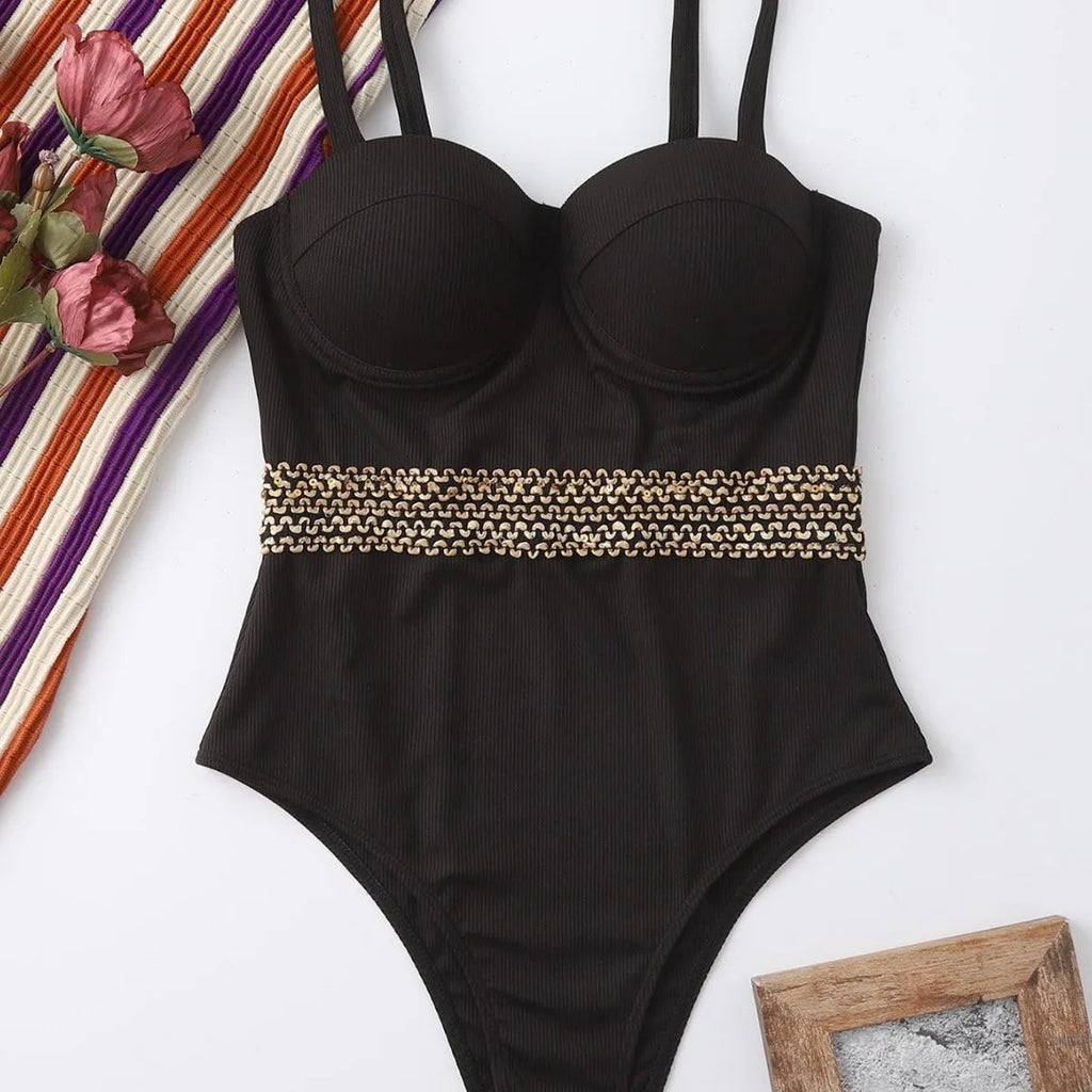 Black women's one-piece swimsuit with adjustable shoulder straps on hanger with hard storage bag