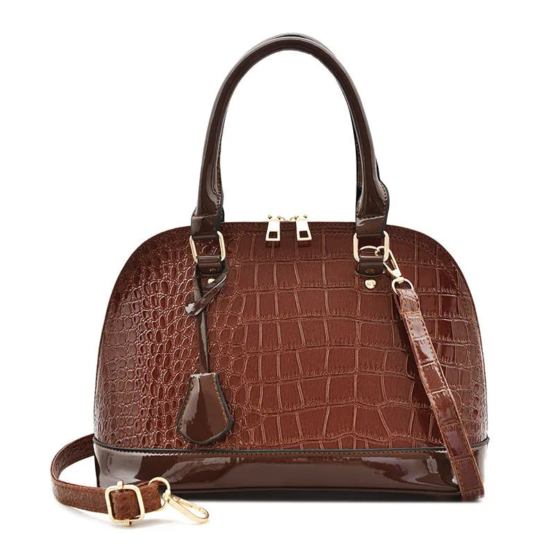Large shiny black PU leather crossbody bag with structured shell shape design.