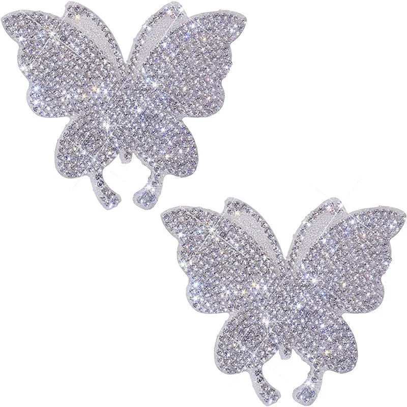 Glass car sticker with diamond-encrusted bear paw or butterfly design on white background.