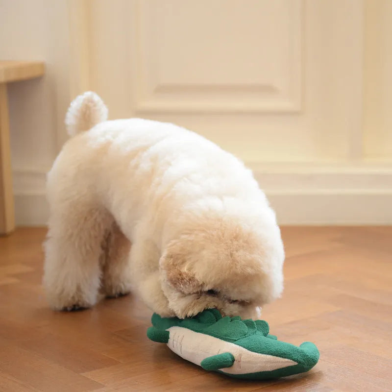 Green plush stuffed toy dog on a white background.