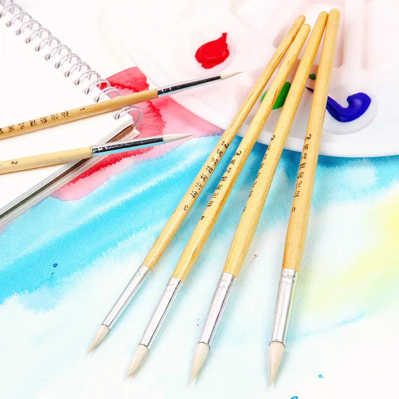 Set of six wooden handled hook line pen brushes with wool pointed tips on a white background.