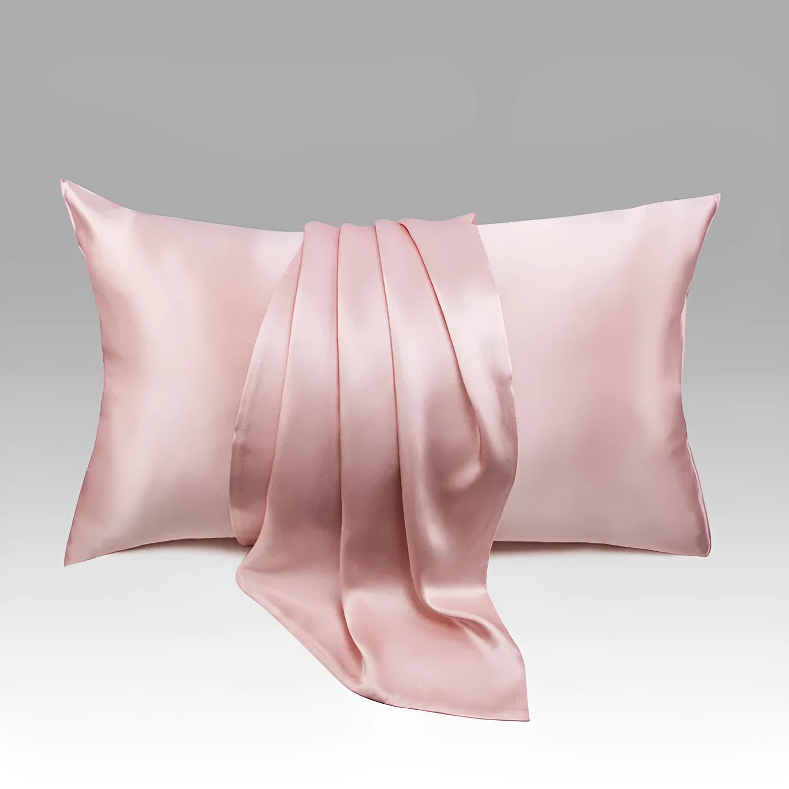 Dark grey silk pillowcase with envelope closure, shown in modern bedding setting.