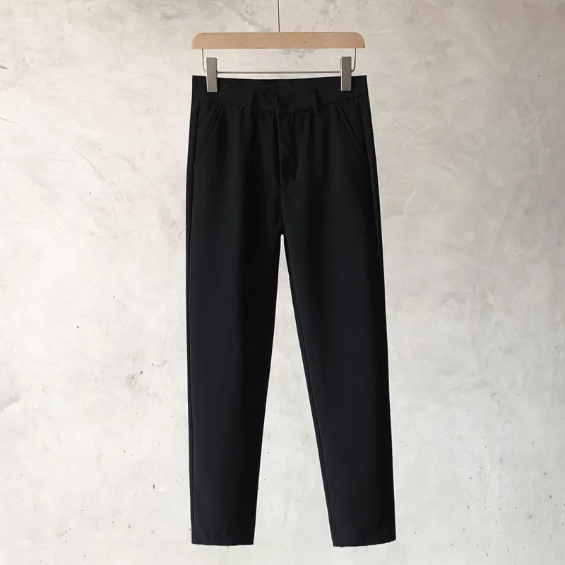 Boy wearing slim straight grey wool blend business casual trousers with a tapered fit