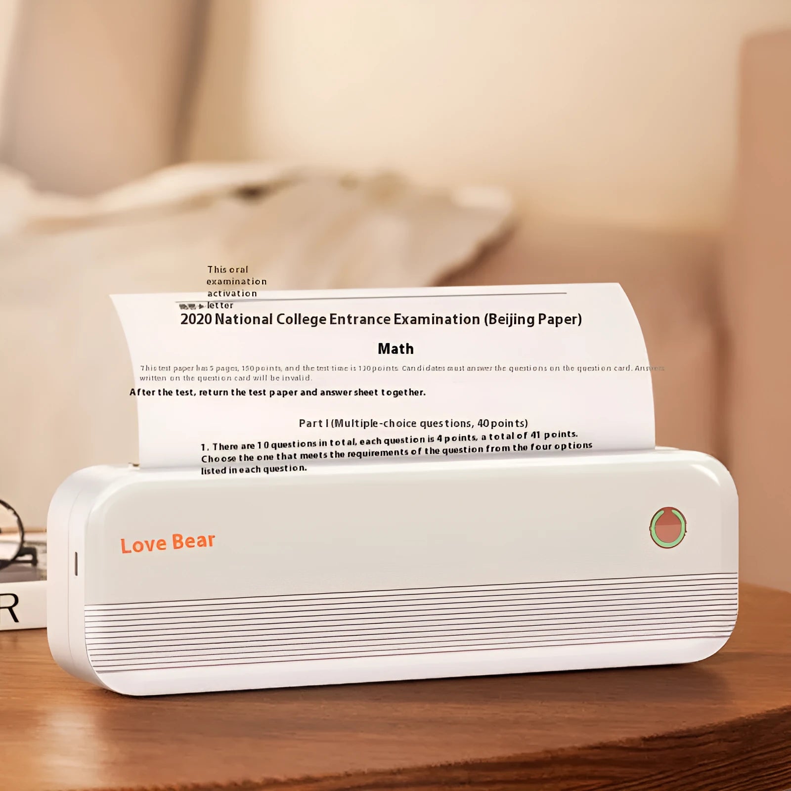 Small white portable thermal printer with USB port on a desk next to A4 paper.