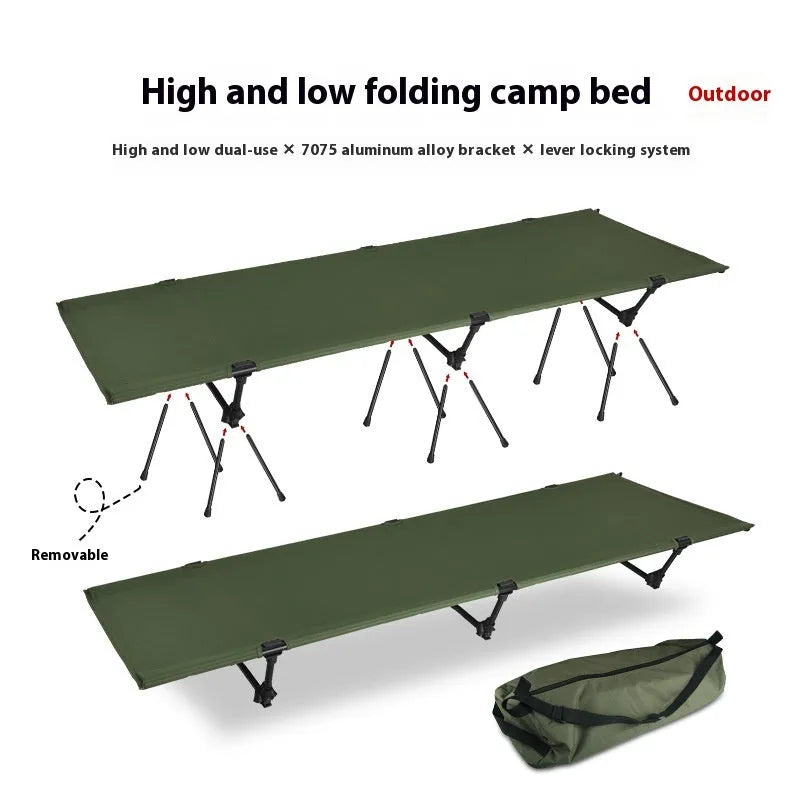 Lightweight portable folding bed set up outdoors in khaki colour with metal frame.