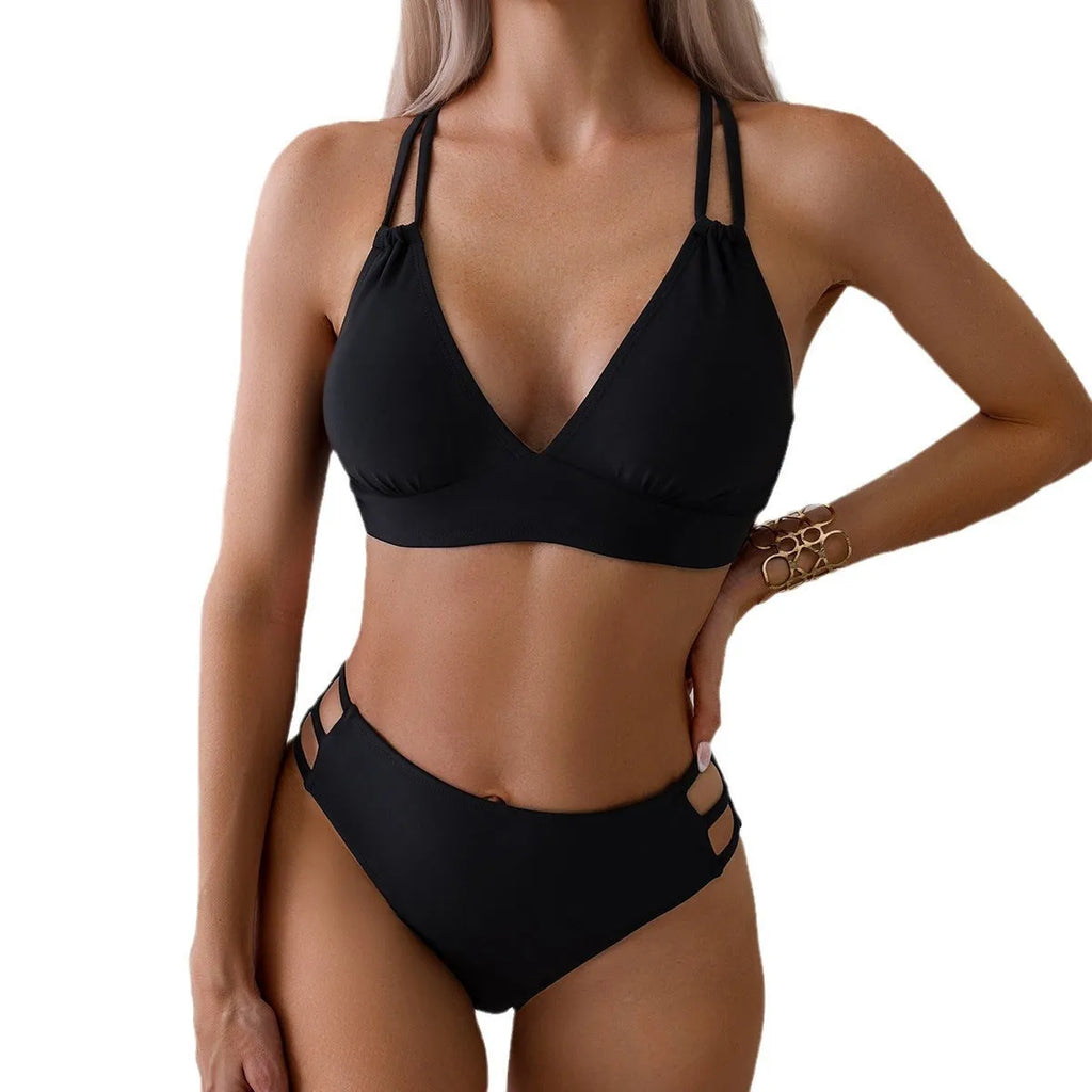 Women's black V-neck halter bikini with split shorts on a neutral background.