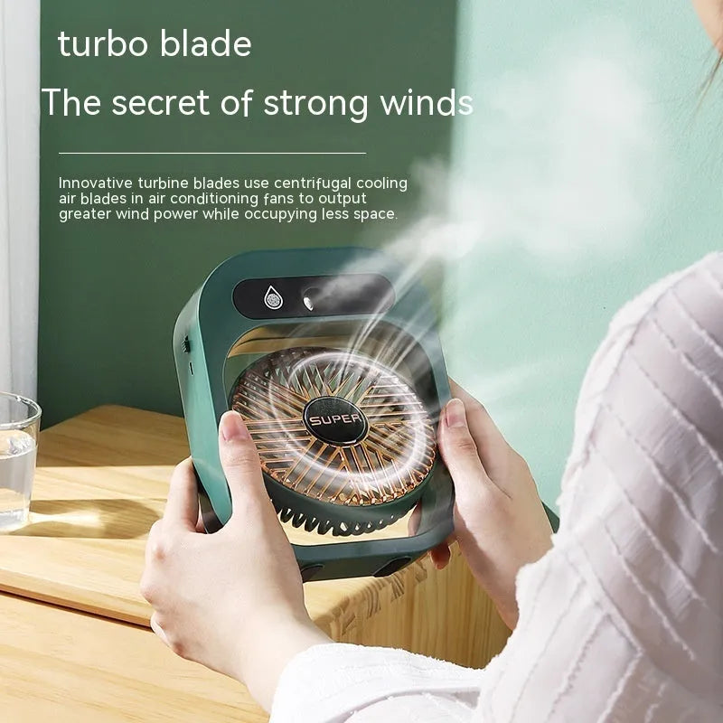 Green and white portable USB misting fan with water tank and adjustable air vent on a desk.
