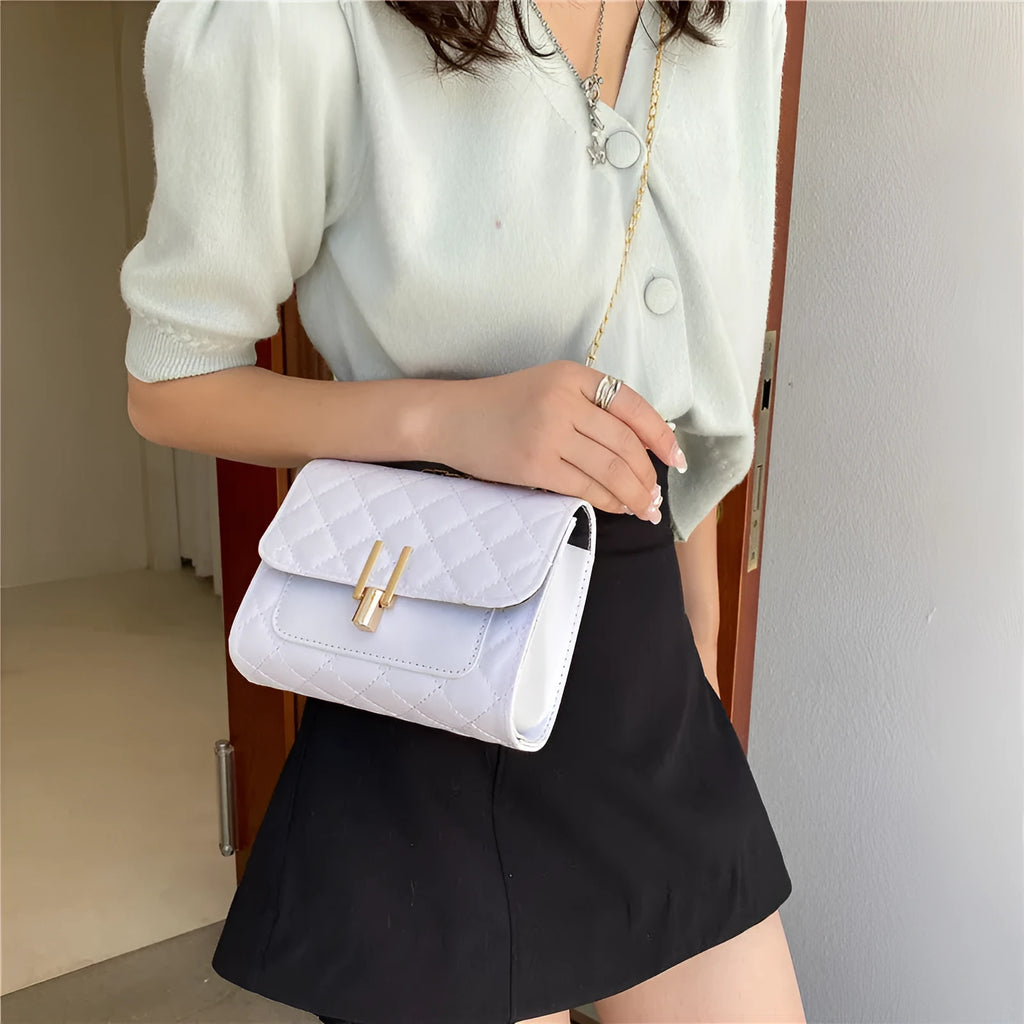 Women's black PU leather crossbody bag with diamond lattice chain detail and adjustable shoulder strap