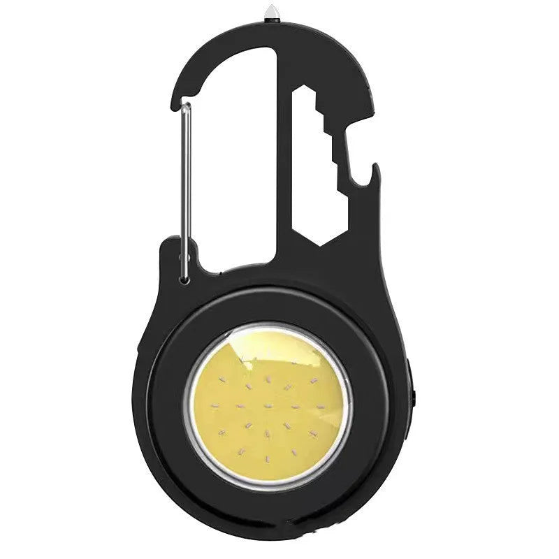 Black 6-in-1 multi-functional mini keychain lamp with COB light and magnetic base on metal surface