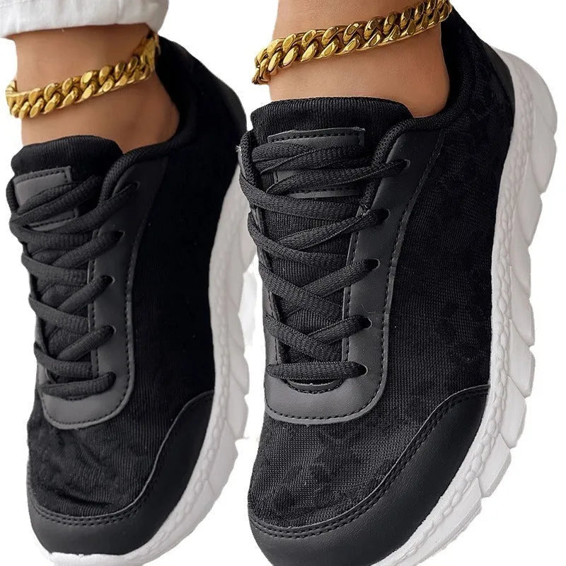 Women's casual canvas sports shoe in four colour options: white, black, blue, and pink, shown with a flat heel.