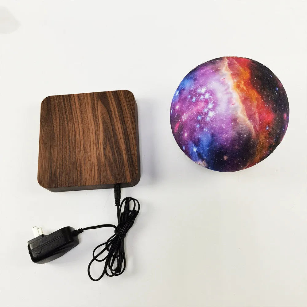 Magnetic levitation galaxy decorative light with a floating walnut-coloured moon lamp above a circular base.