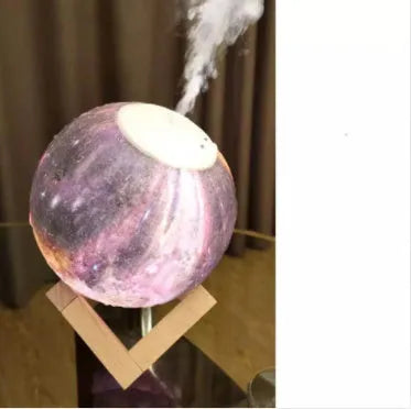 Wood finish spherical lunar humidifier and night light on a bedside table.