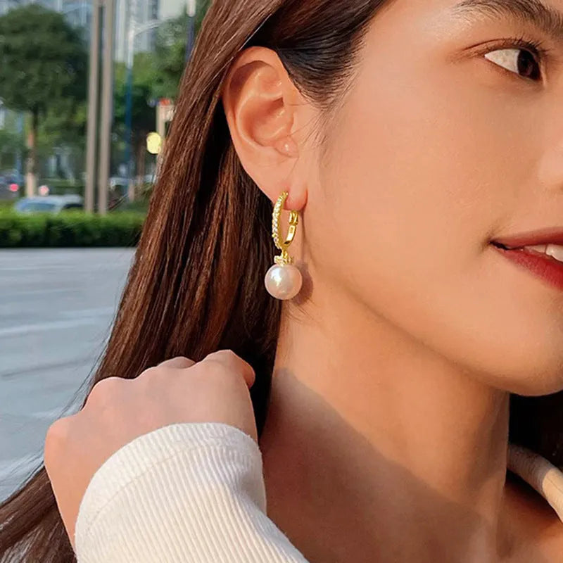 Yellow gold finish earrings with imitation pearls and inlaid zircon on copper base