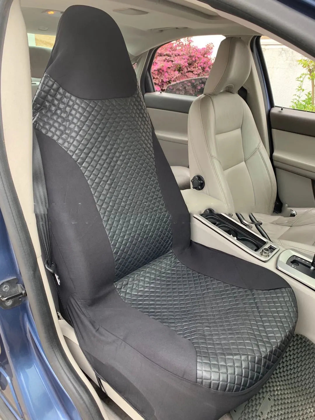 Black quilted automotive seat cover made of PU and polyester with plastic hooks.